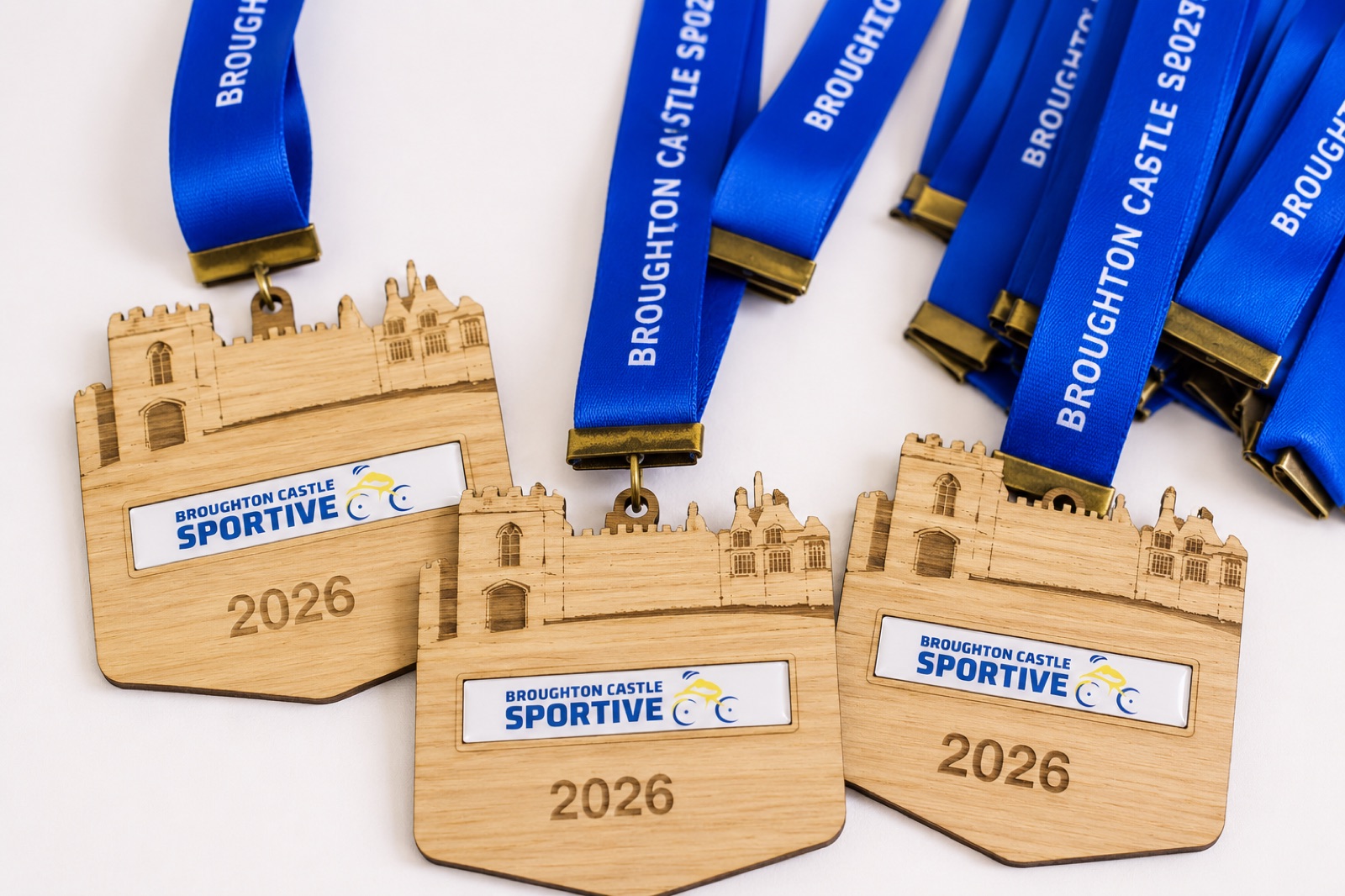 Custom laser-cut wooden medals with blue ribbons